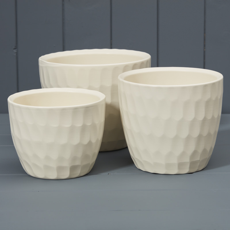 Set of three carved pots 